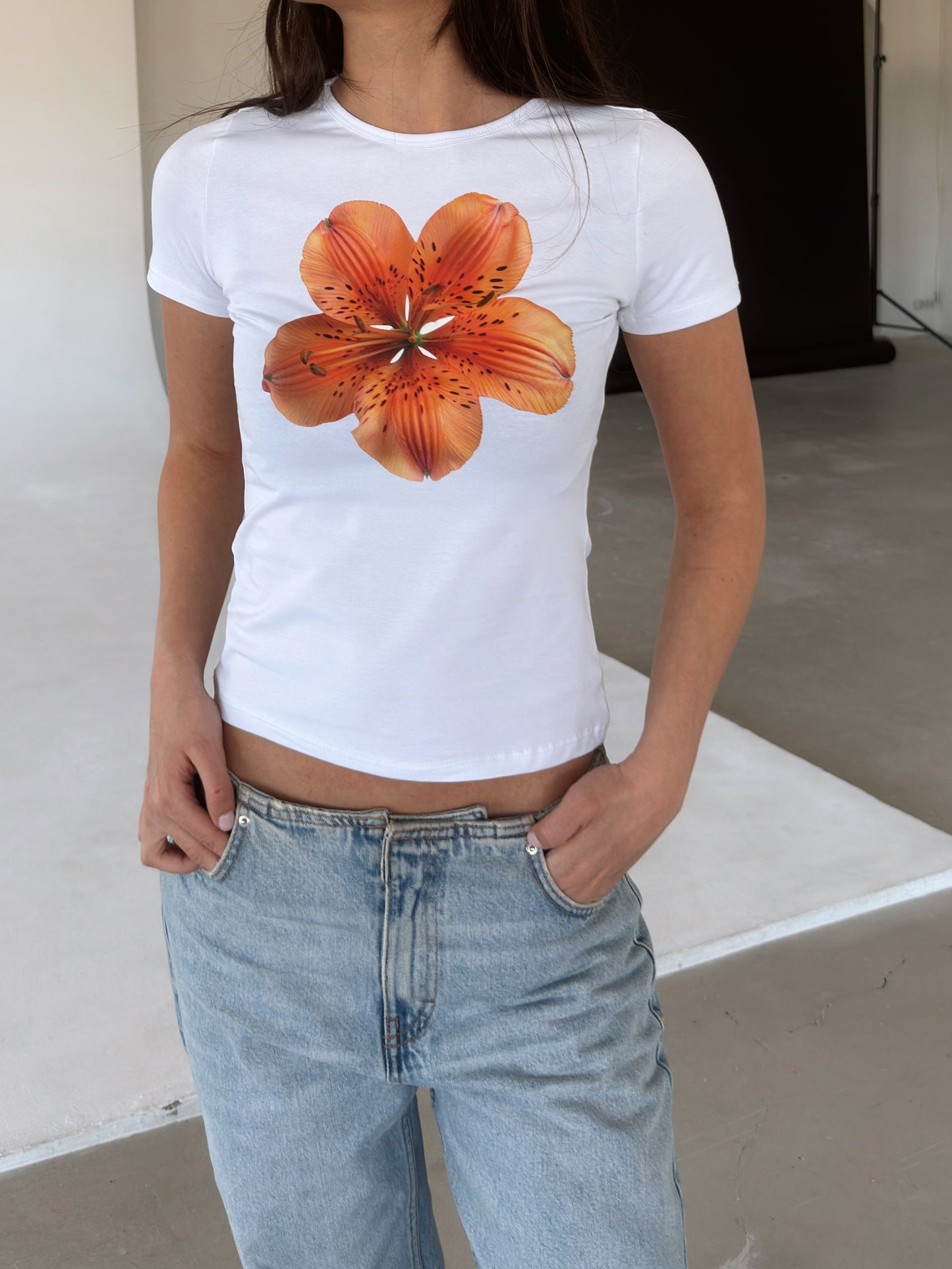 White top with orange flower