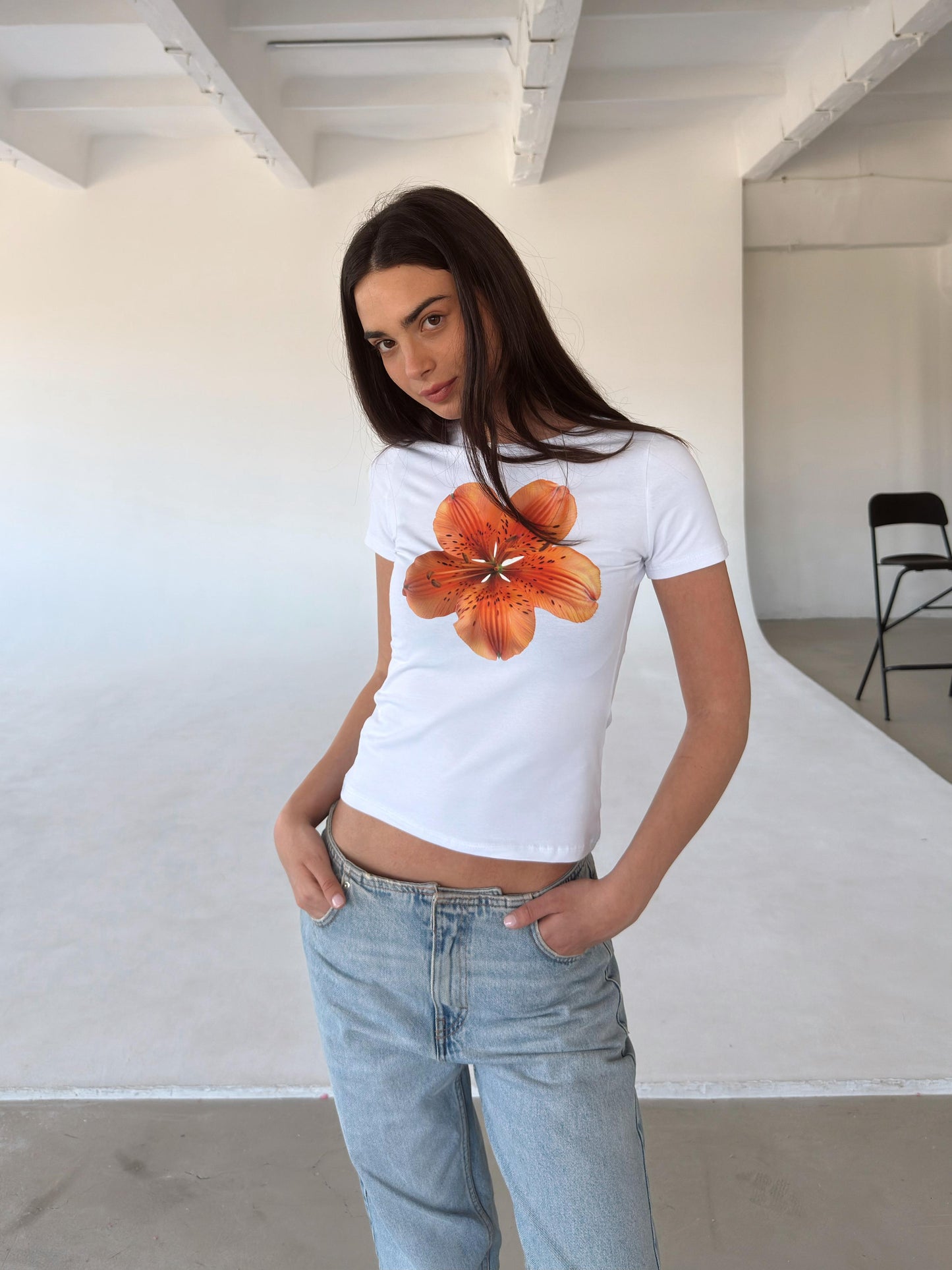 White top with orange flower