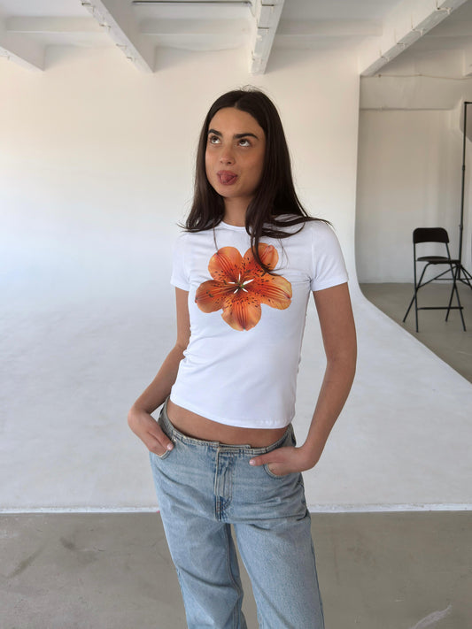 White top with orange flower